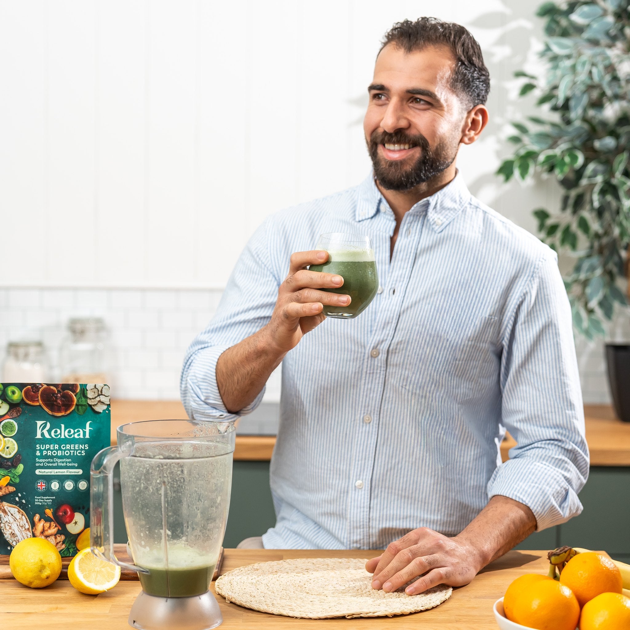 Releaf founder raising a glass of freshly made Super Greens