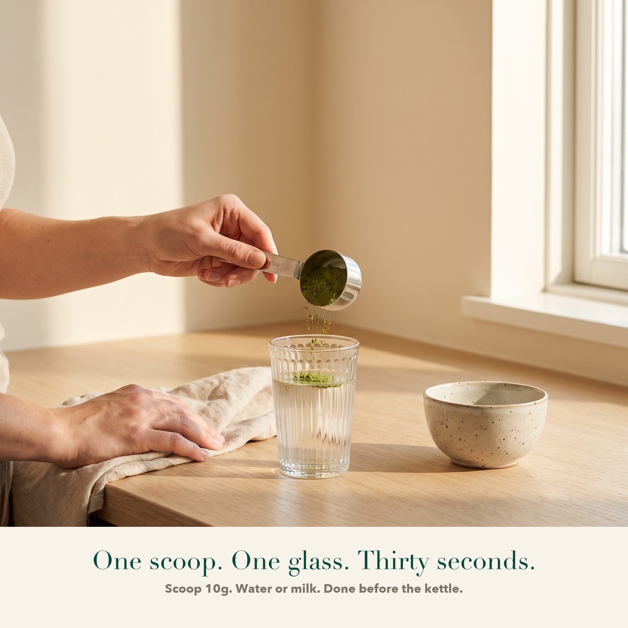 A 10g scoop of Releaf greens being tipped into a glass of water. One scoop, one glass, thirty seconds