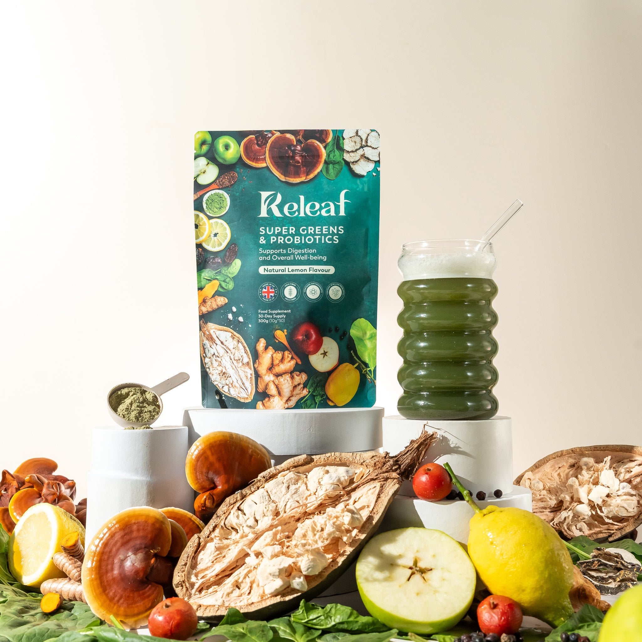 Releaf Super Greens pouch surrounded by its organic ingredients - reishi, baobab, lemon, apples, turmeric and spinach