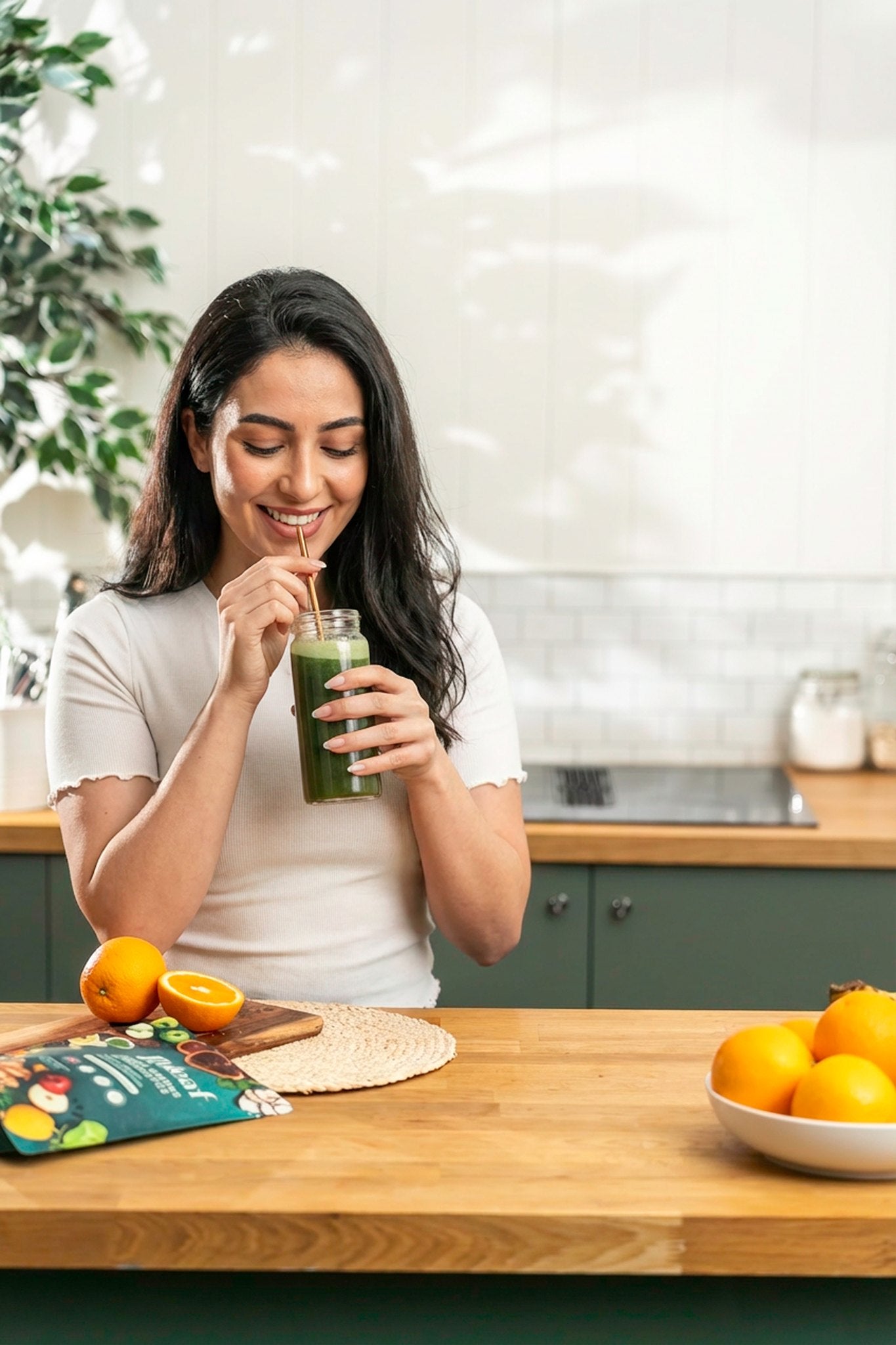 Woman sipping a Releaf Super Greens lemon drink through a straw